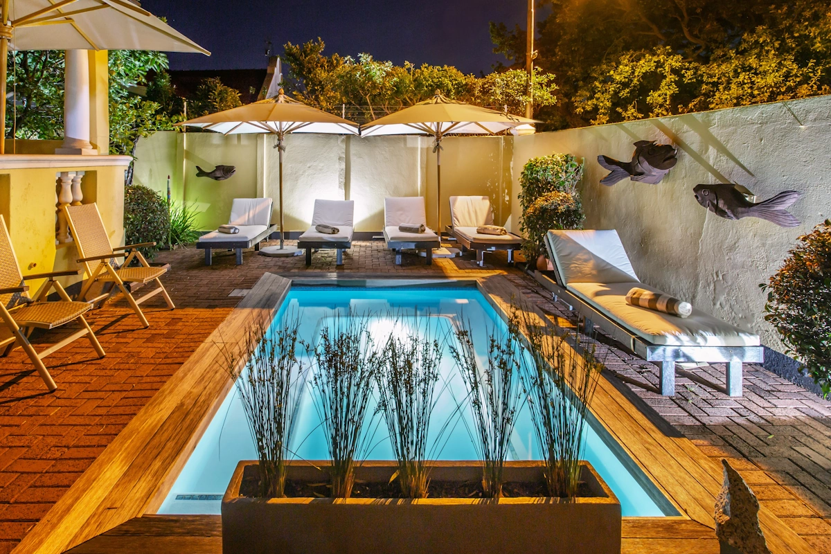 Toms Guest House zwembadje ligbedden.webp